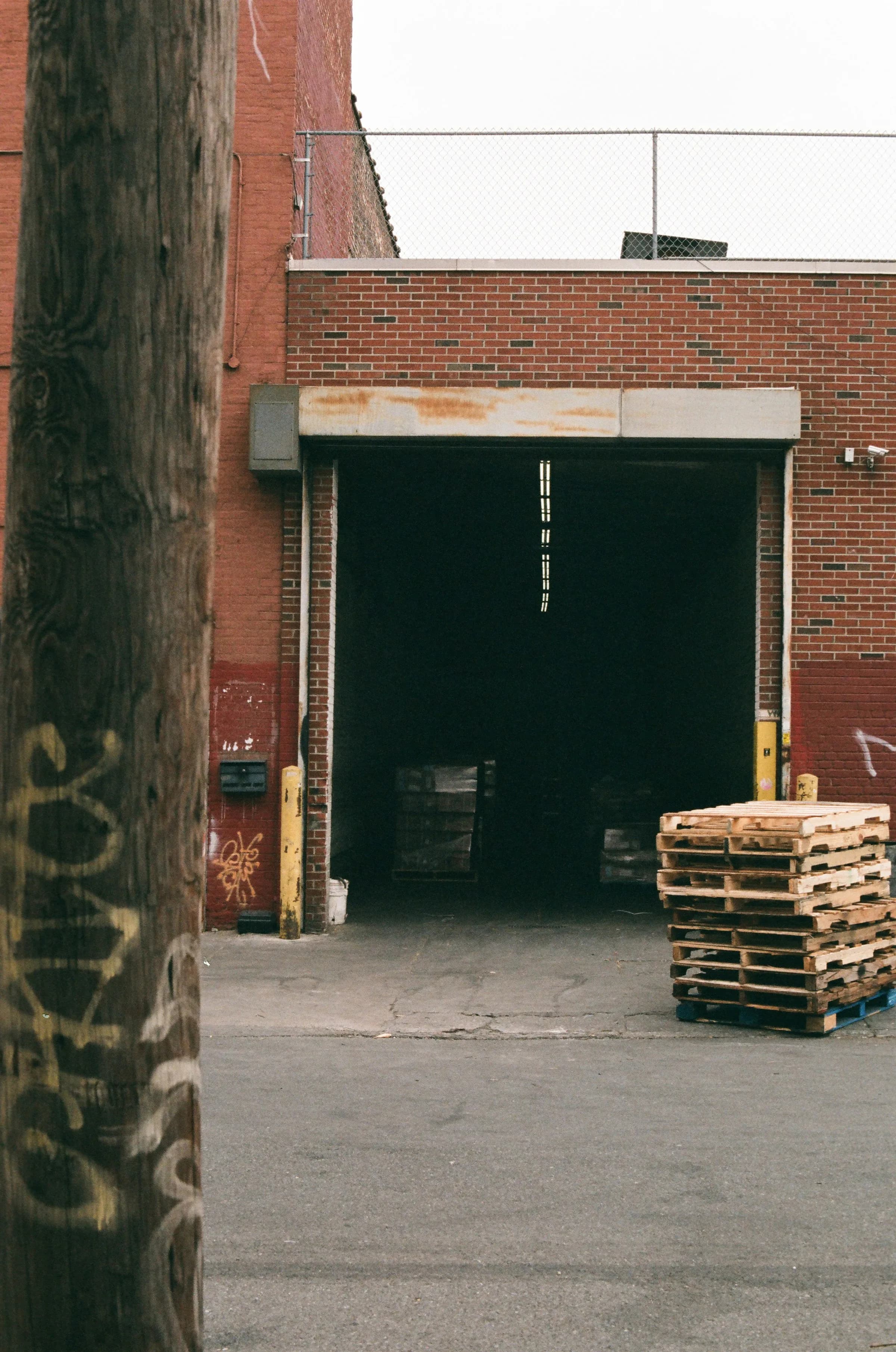 Working warehouse loading entrance with pallets and an exterior security camera